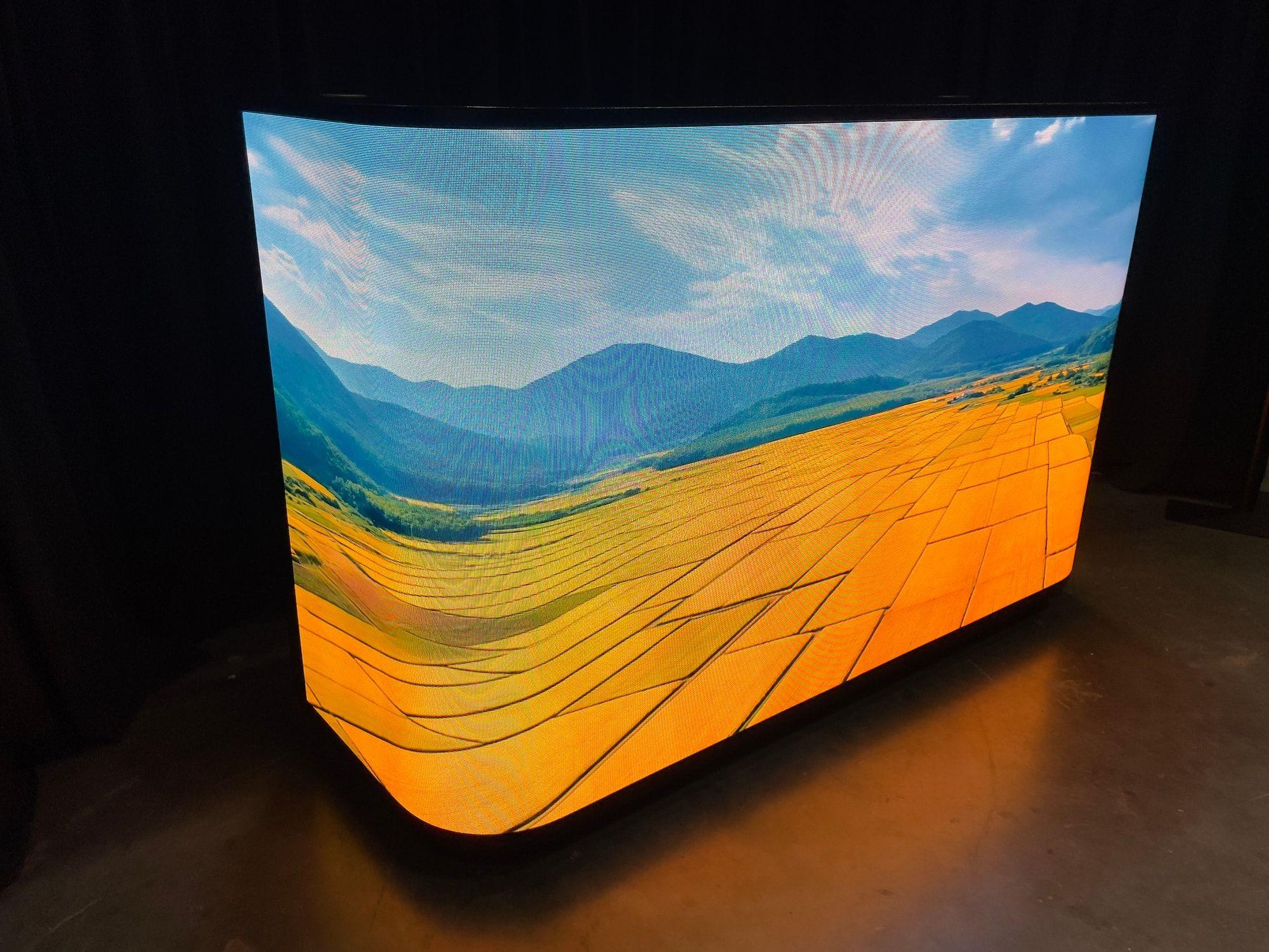 66-inch curved LED counter wrapping the front and corners of a booth