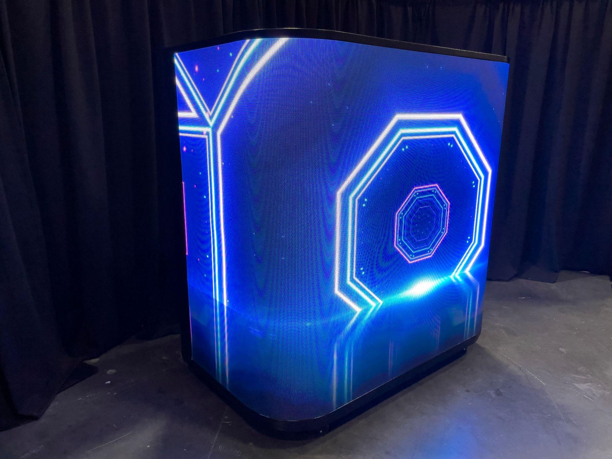 Curved LED reception counter showing animated content