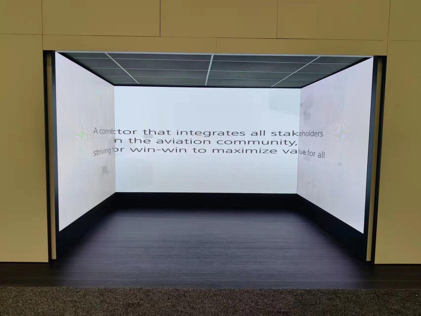 Concave LED video wall curving around a darkened presentation space
