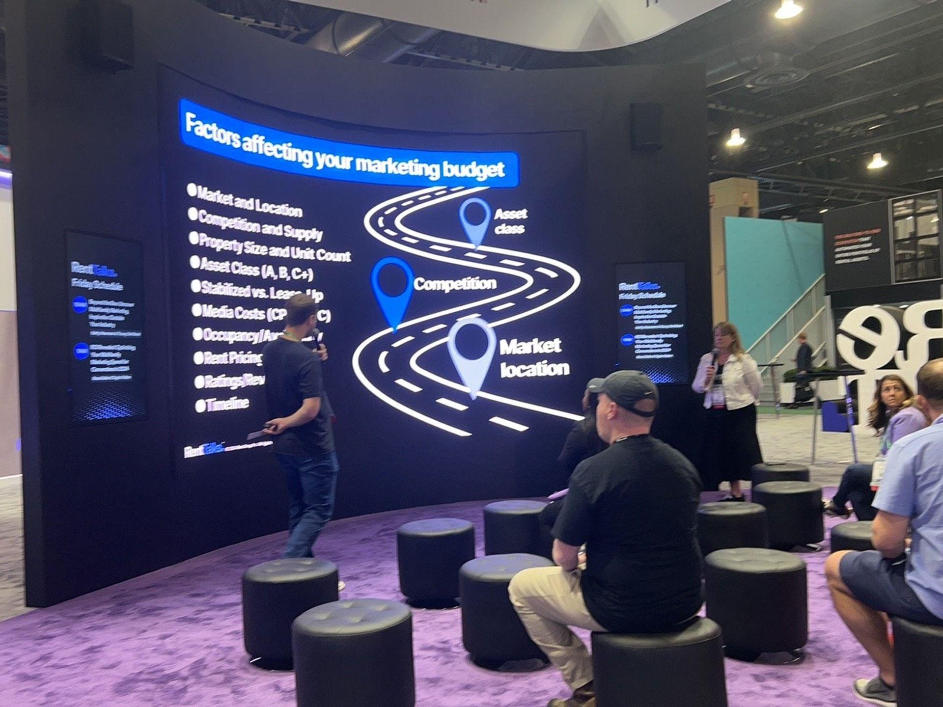 Curved LED wall with branded blue content on a show-floor booth