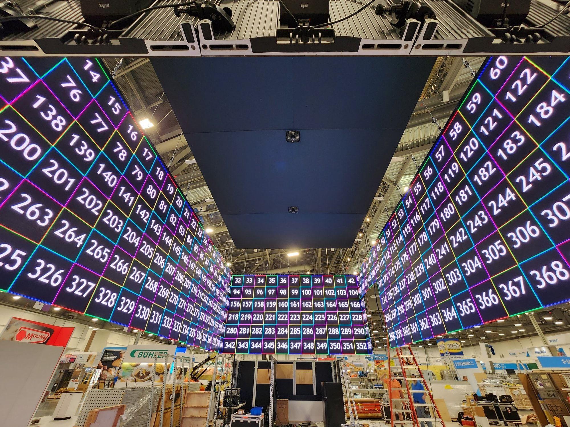 Large freestanding LED video wall filling an event hall
