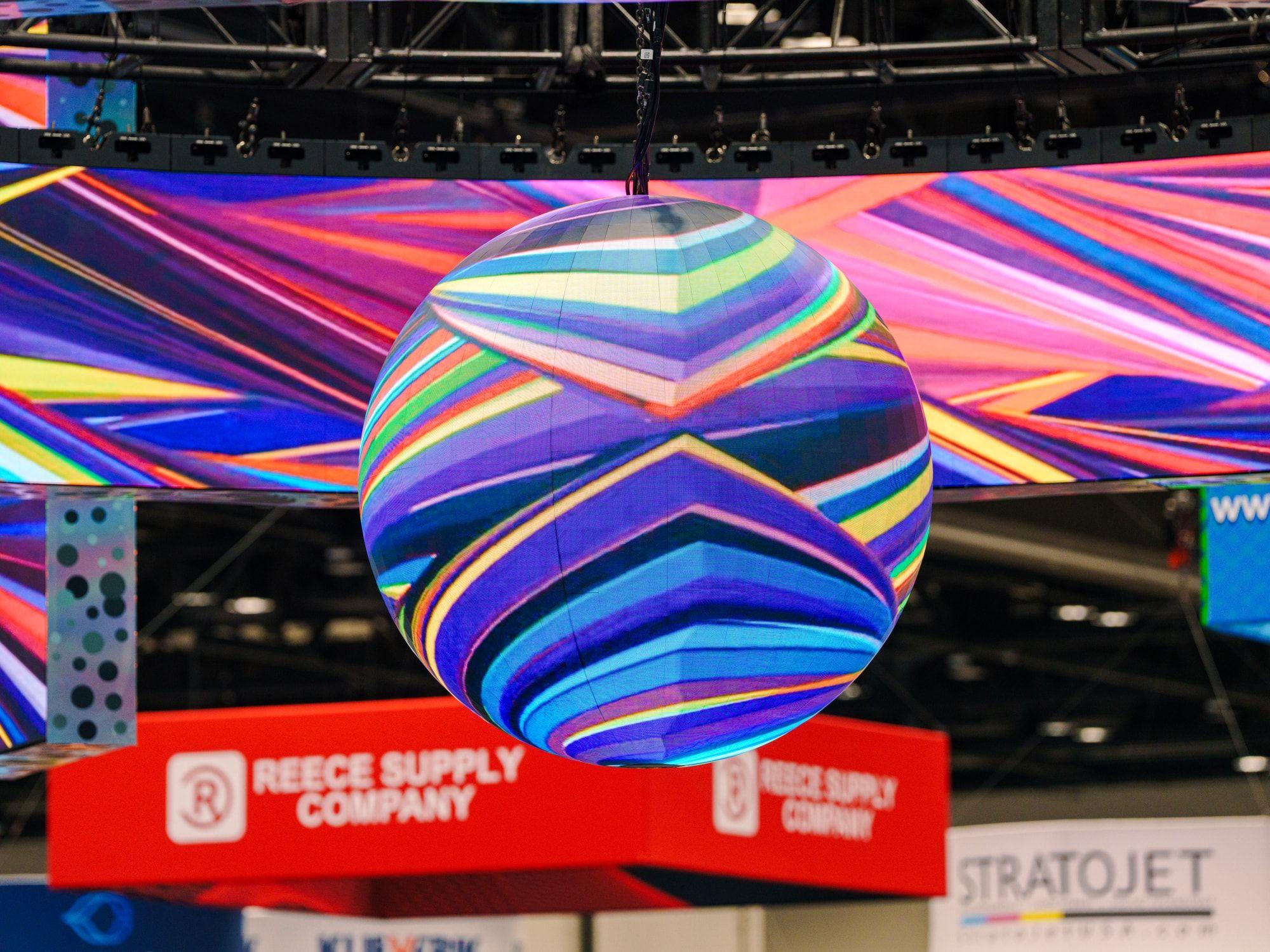 360-degree LED sphere rigged inside an LED ring at a trade show booth