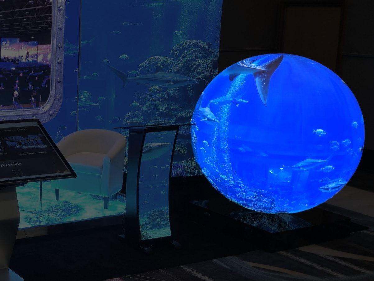 LED sphere playing underwater content on a trade show booth