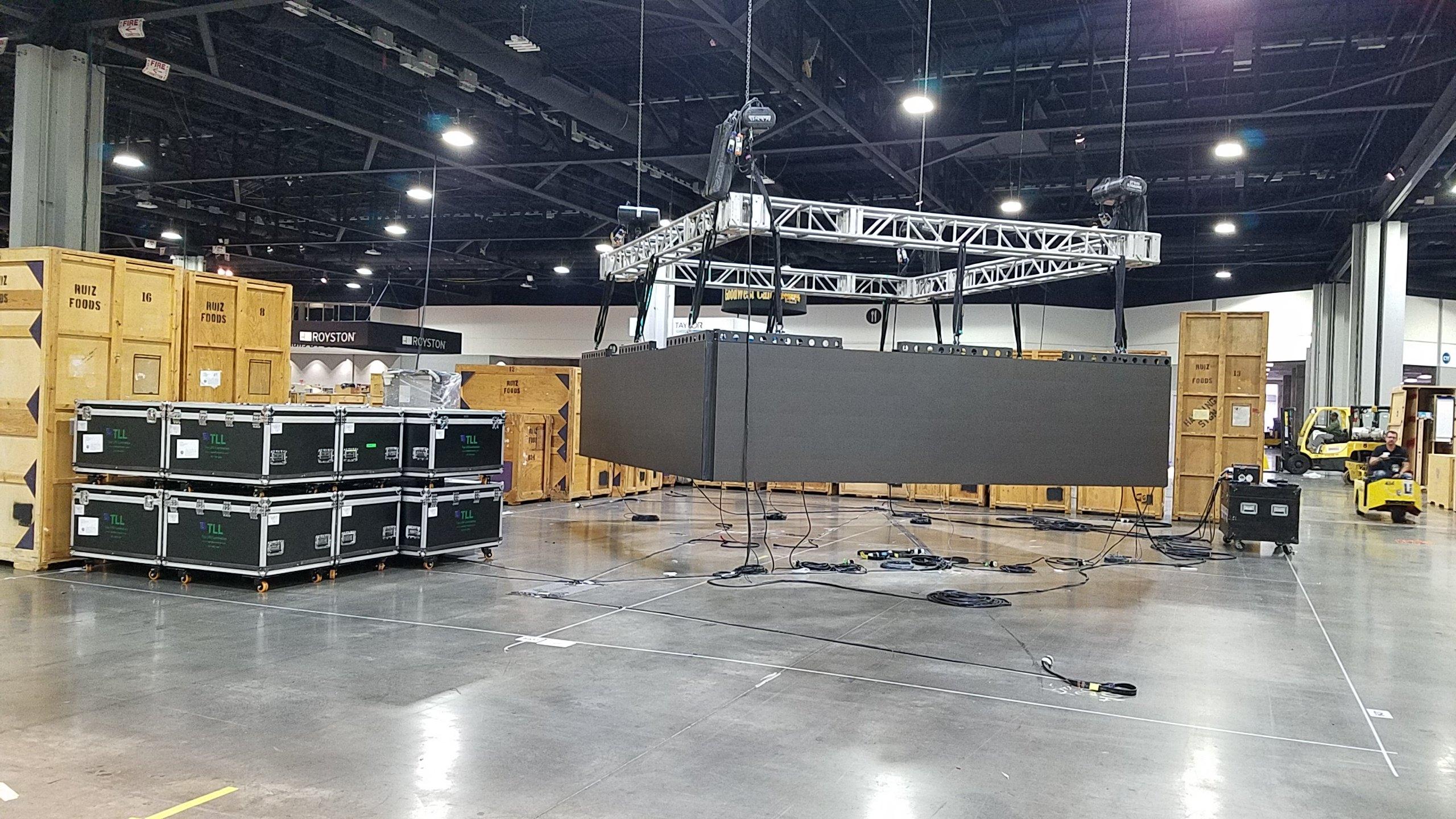 A wall of LED and AV rental gear staged on a show floor