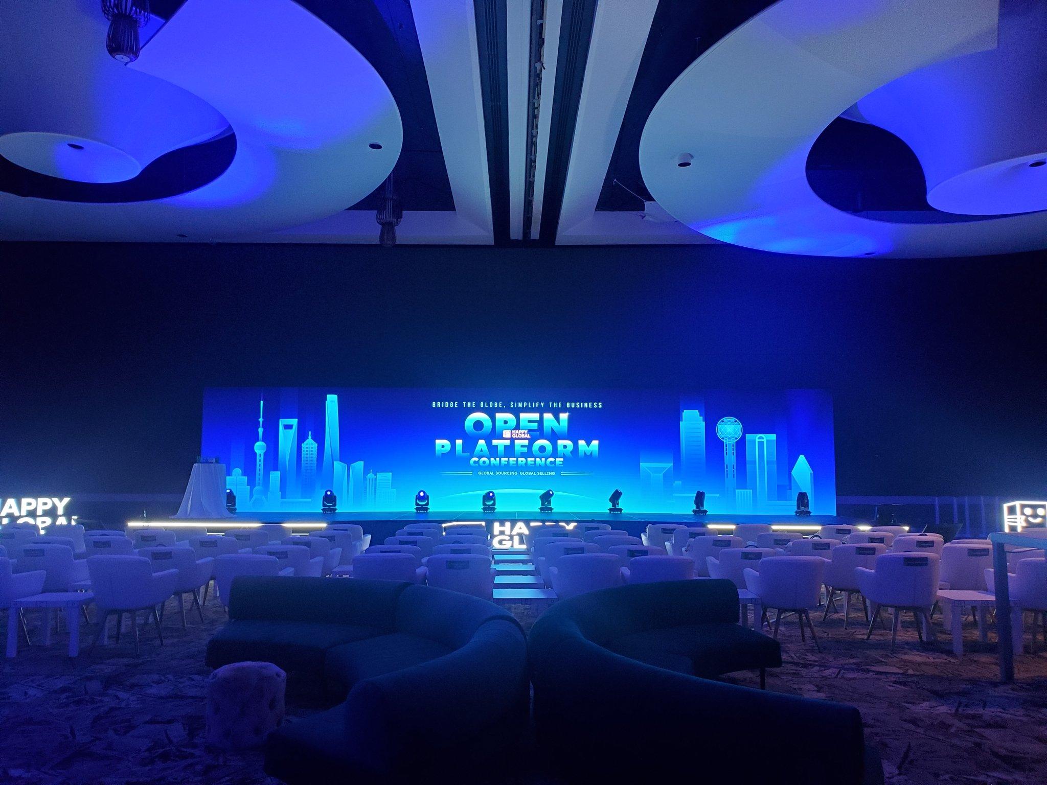 Keynote speaker at a lectern on stage under show lighting