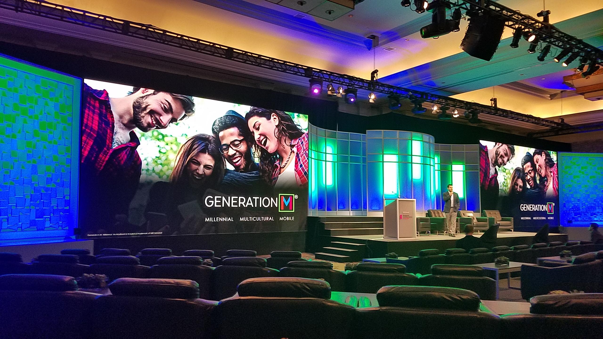 A keynote stage lit by LED walls