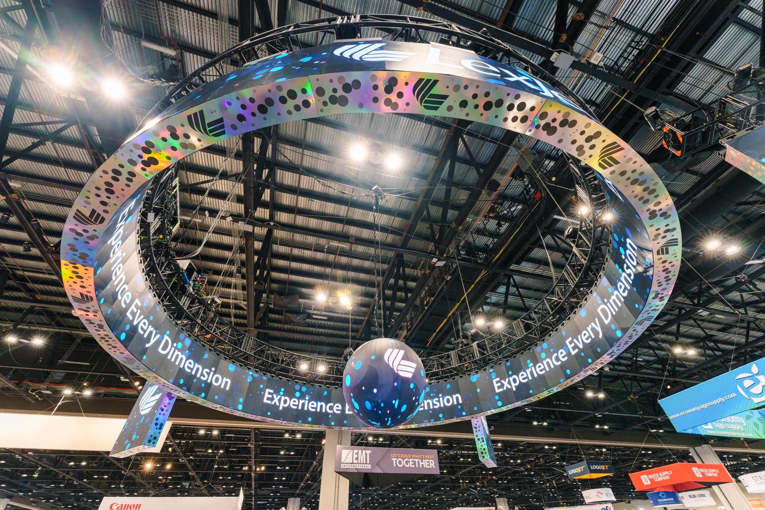 Full booth build with LED walls, video, and furniture surrounding the central LED sphere