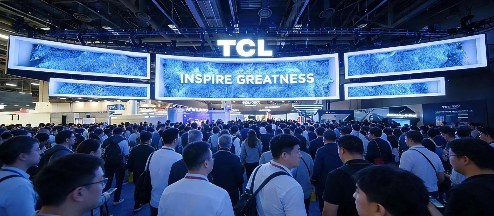 TCL at CES: A 120-foot ultra-wide LED banner over the entrance, a live-production stage, and a monolithic LED column, all playing as one continuous image.